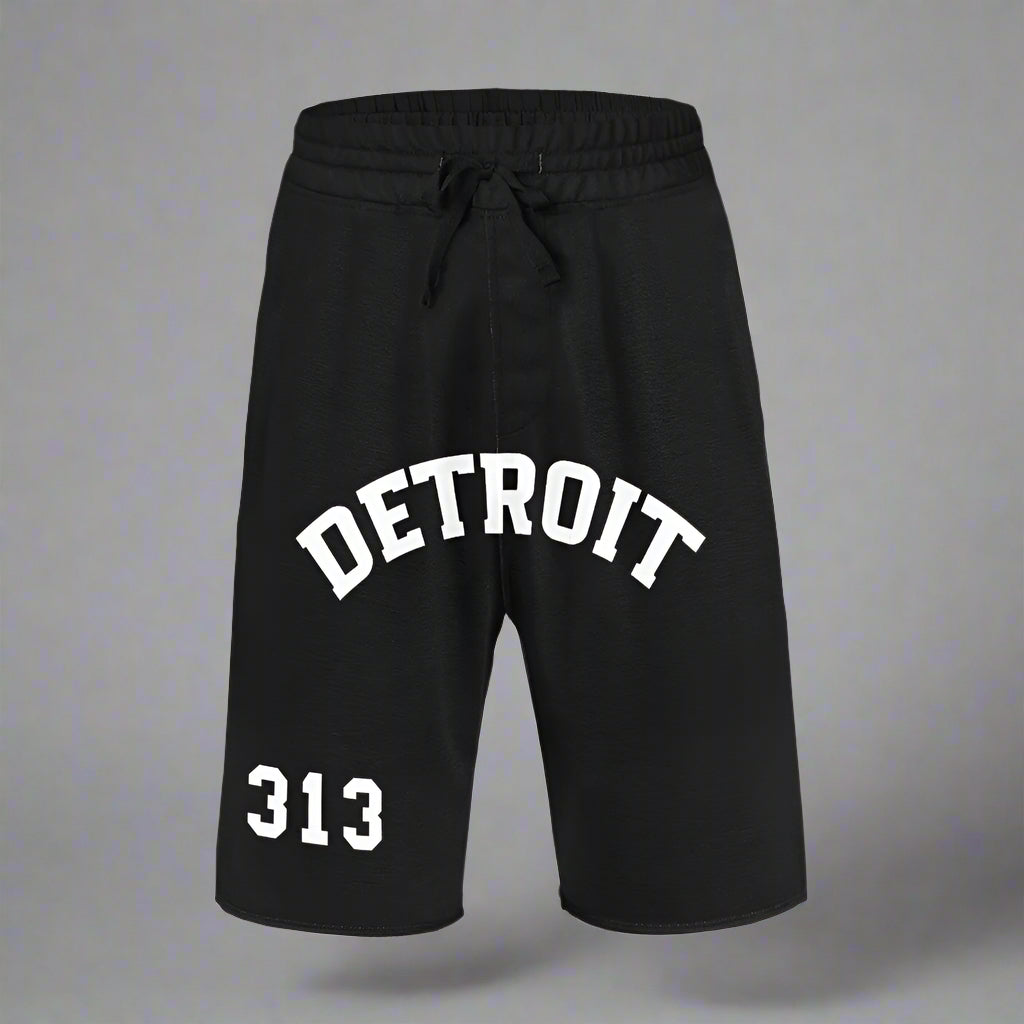 Black athletic shorts displayed flat against a gray background. The shorts feature a white drawstring waistband and white printed text. The word 'DETROIT' is arched across the front, while the number '313' is printed in bold white block letters on the lower left leg