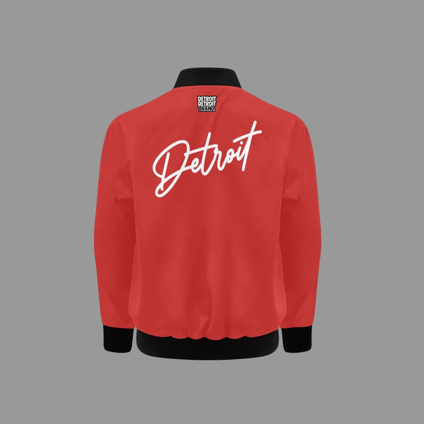 Red kids bomber jacket with “Detroit” written in bold white script across the chest, featuring a gold zipper and black ribbed collar, cuffs, and hem.