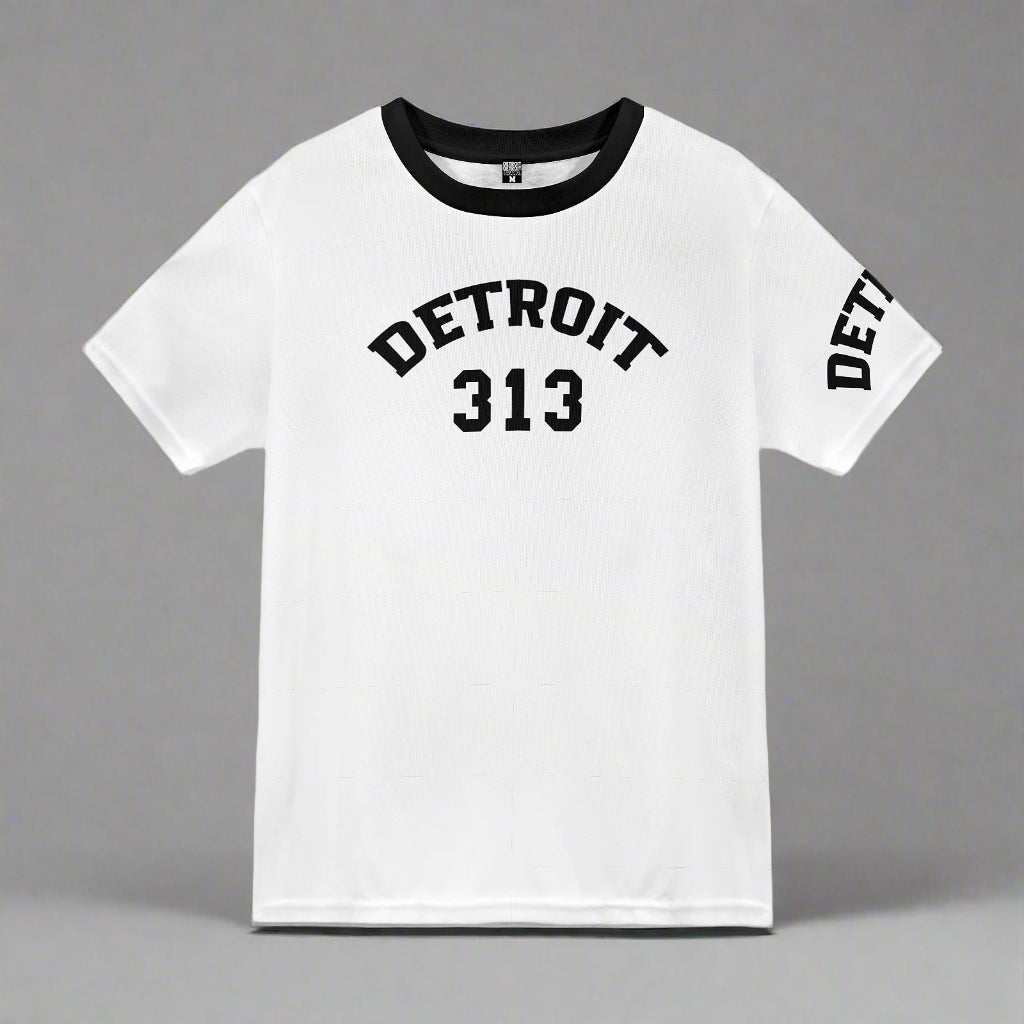 White short-sleeve t-shirt displayed flat against a gray background. The shirt features black text with the word 'DETROIT' arched above the number '313' on the front. The left sleeve also displays the word 'DETROIT' in black capital letters. The shirt has a black crew neckline, adding a contrasting accent