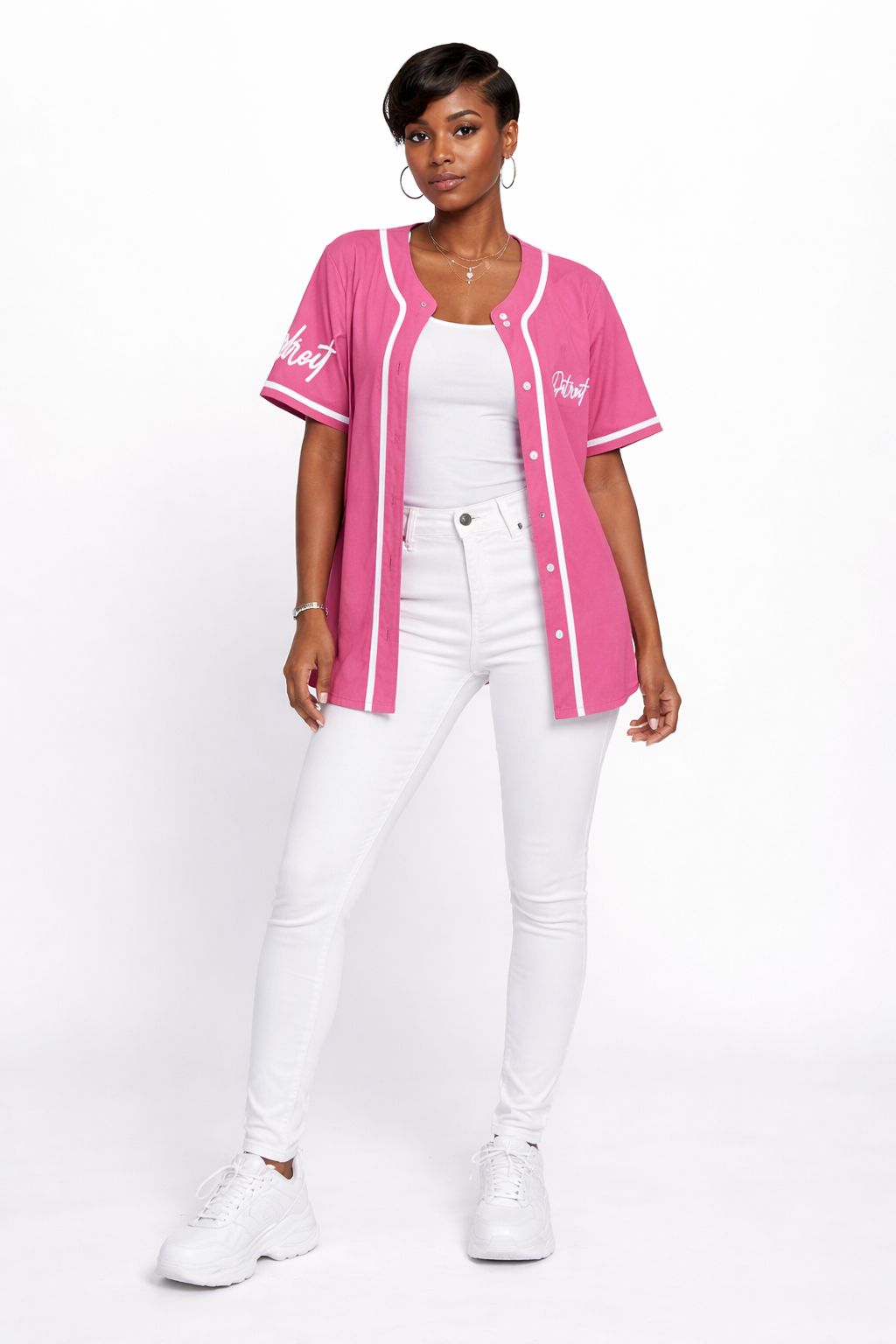 Woman wearing pink Detroit baseball jersey styled with white jeans and sneakers, full body front view