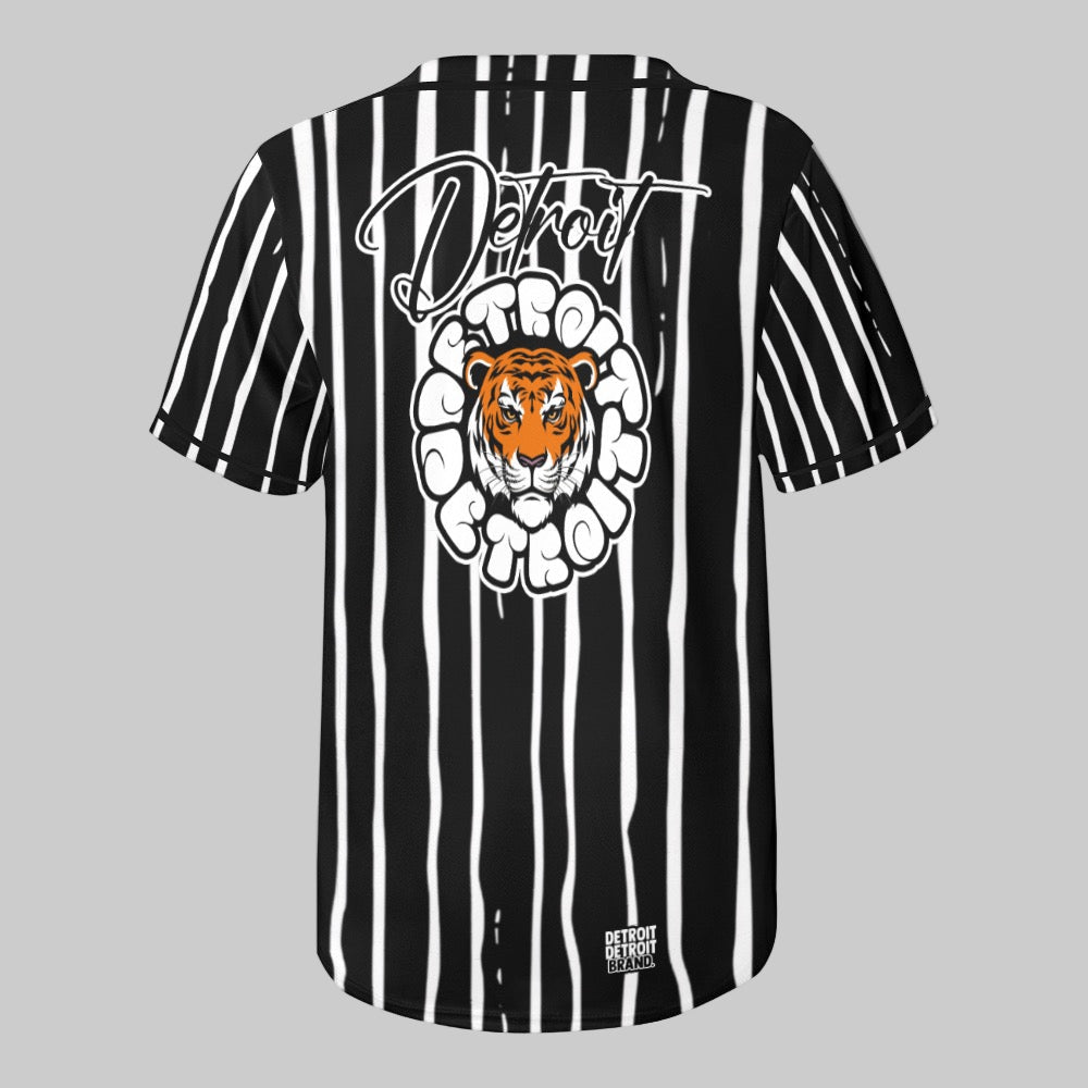 Back view of a black and white striped baseball jersey featuring a bold orange tiger head graphic and large white “Detroit” script above it.
