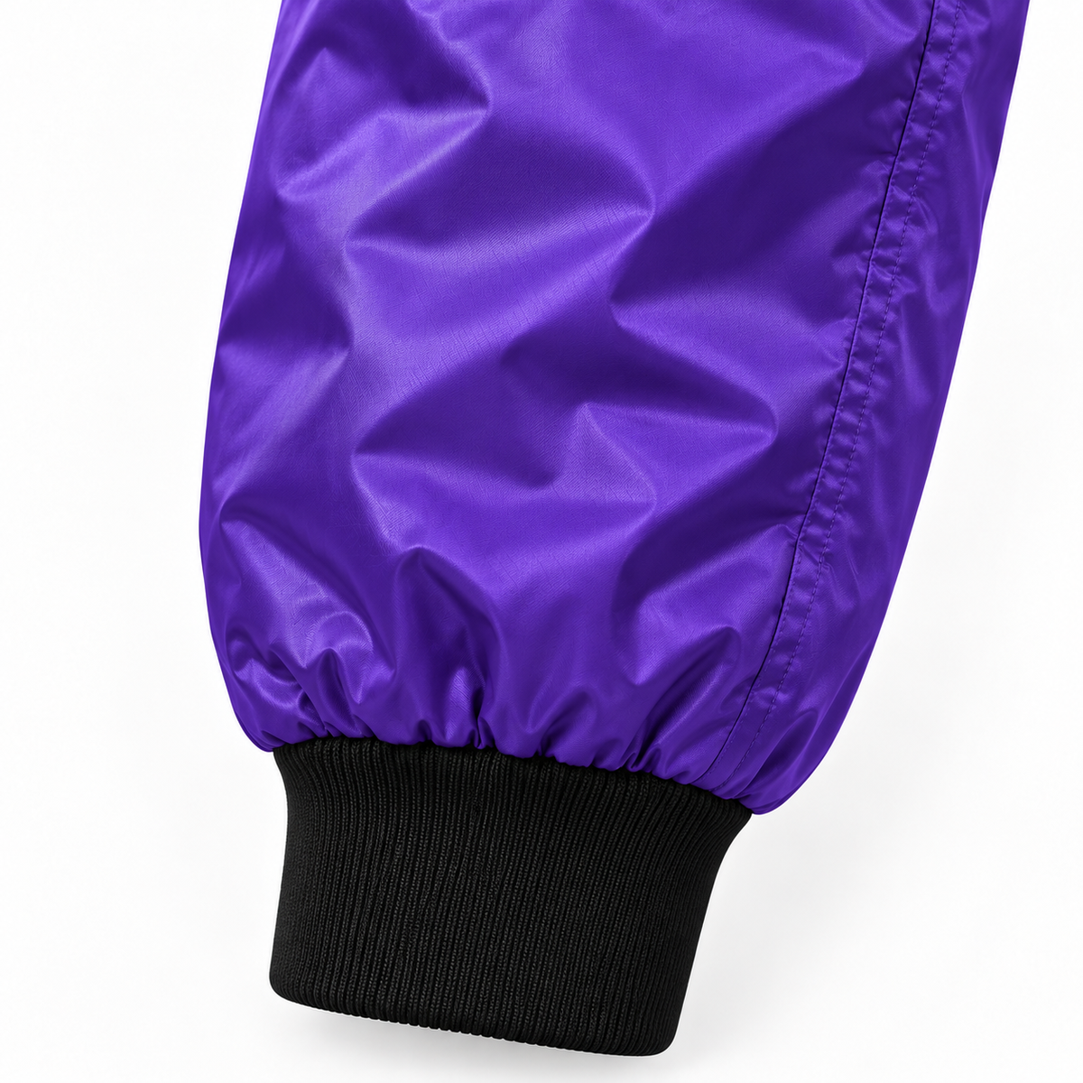 Close-up of purple Detroit bomber jacket sleeve showing lightweight fabric and black ribbed cuff