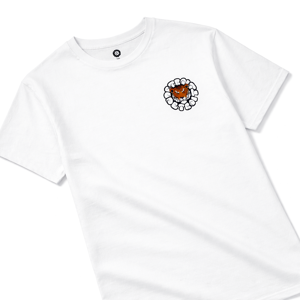 Close-up angled flat lay of white graphic t-shirt rotated right, highlighting tiger logo on chest with detailed fabric texture, premium streetwear product image on white background