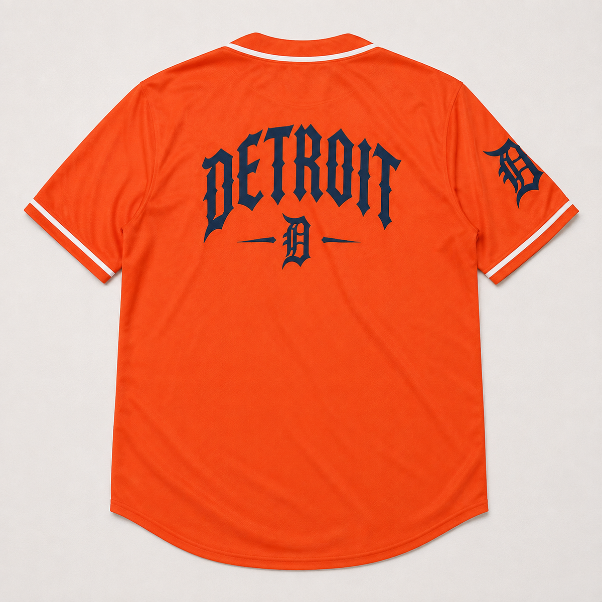 Bright orange Detroit Tigers baseball jersey shown from the back, featuring navy blue gothic 'DETROIT' lettering with a large 'D' logo and white trim on the collar and sleeve cuffs.