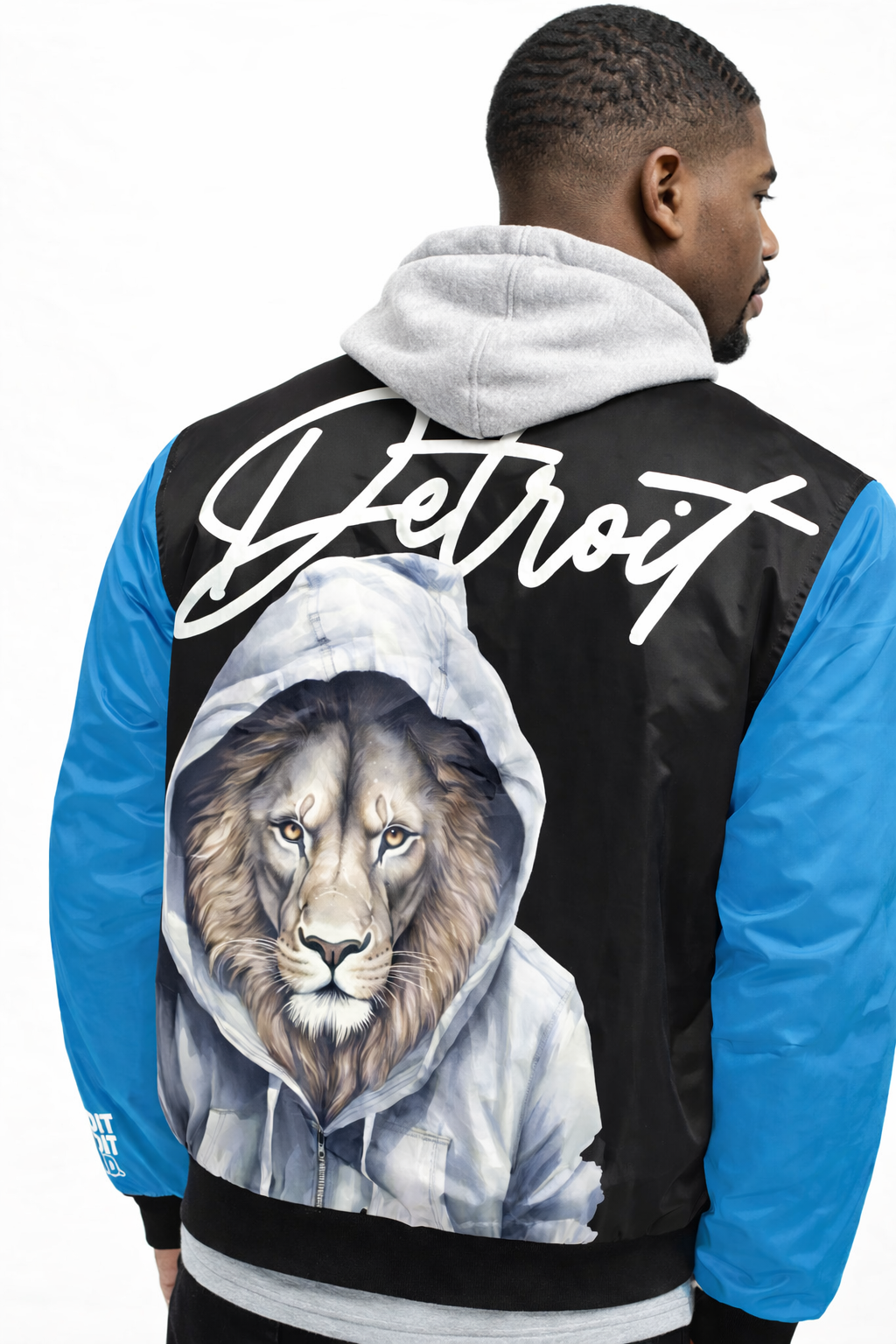 Person wearing a jacket with a lion graphic and 'Detroit' text on the back