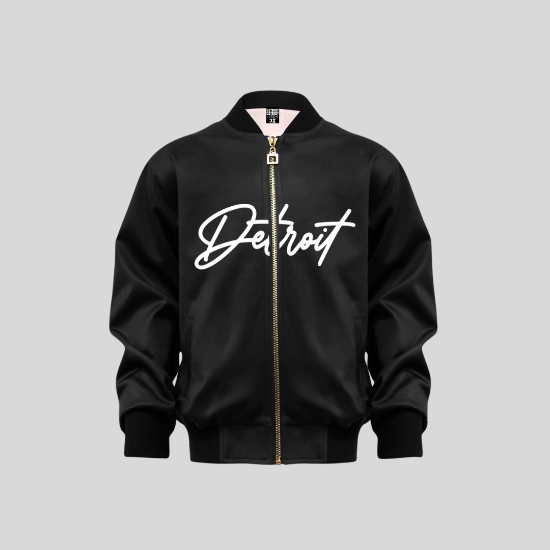 Black kids bomber jacket with “Detroit” written in bold white script across the chest, featuring a gold zipper and ribbed cuffs and hem.