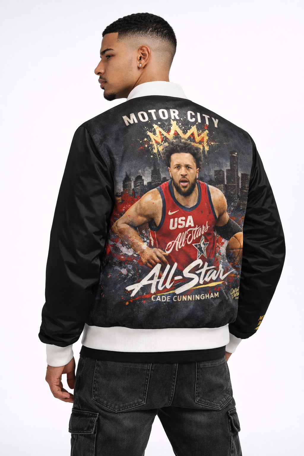Person wearing a black jacket with a graphic of a basketball player Cade Cunningham and text on the back, on a white background.