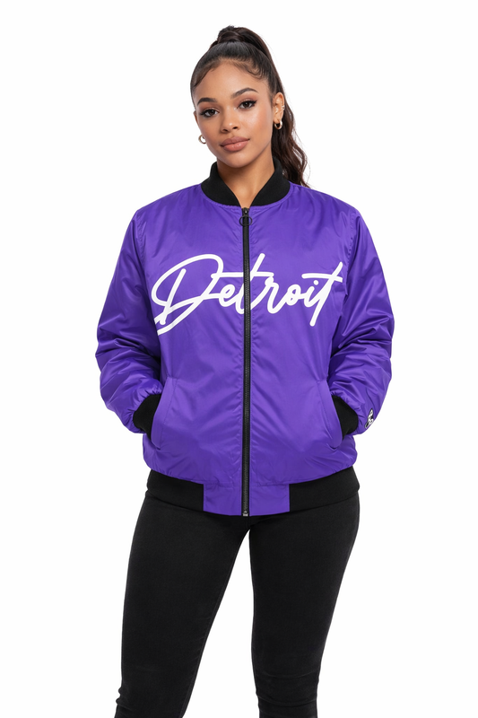Person wearing a purple jacket with 'Detroit' text on a white background