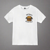 "White short-sleeve t-shirt laid flat on a gray background. The front of the shirt features a &