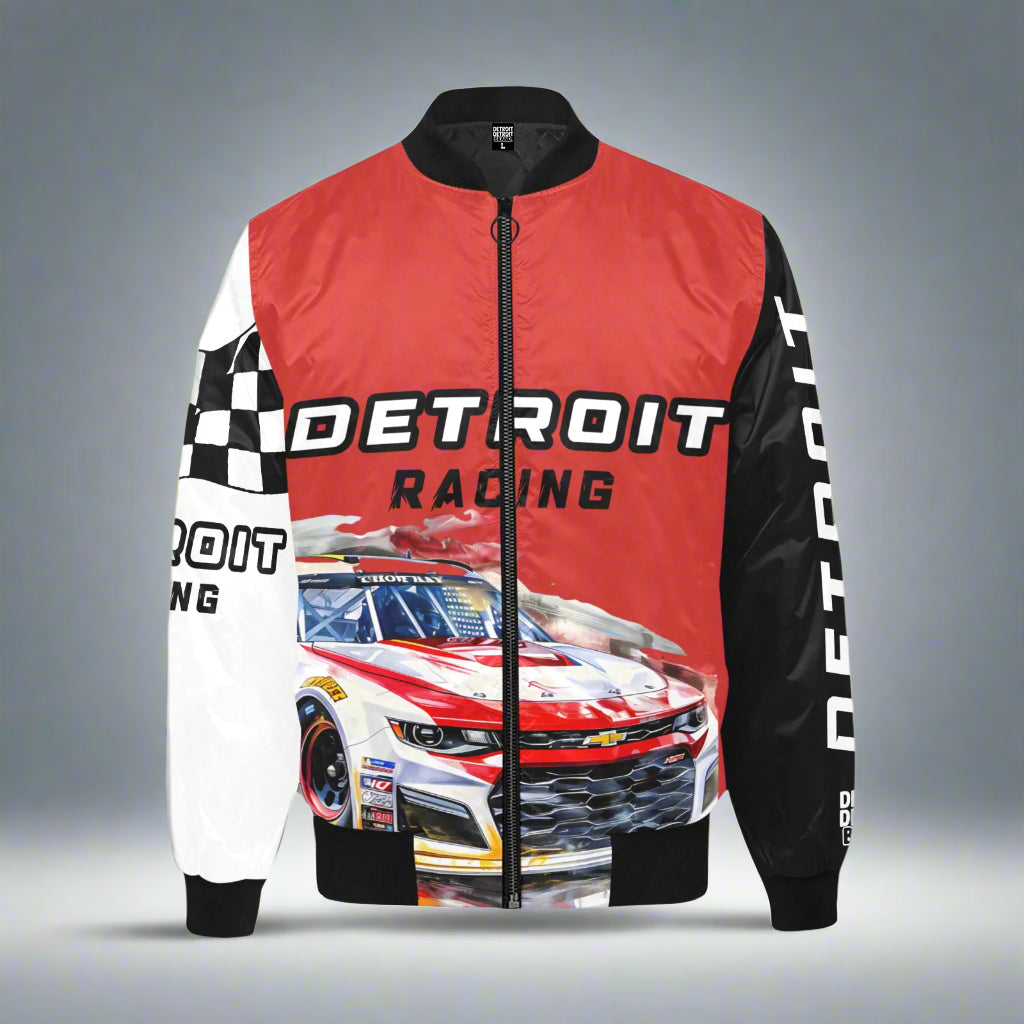 Detroit racing-themed bomber jacket displayed flat against a gray background. The jacket features a red upper front with the words 'DETROIT RACING' in bold black and white lettering. The lower front showcases a detailed graphic of a red and white race car. The left sleeve displays a black and white checkered flag pattern with additional 'DETROIT RACING' text, while the right sleeve is solid black with 'DETROIT' printed vertically in white. Rep Detroit Grand Prix