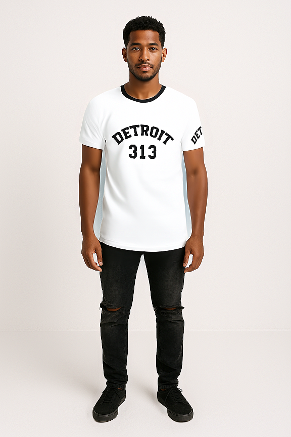 A man standing against a light-colored background, wearing a white t-shirt with a black crew neckline. The front of the t-shirt features the word &