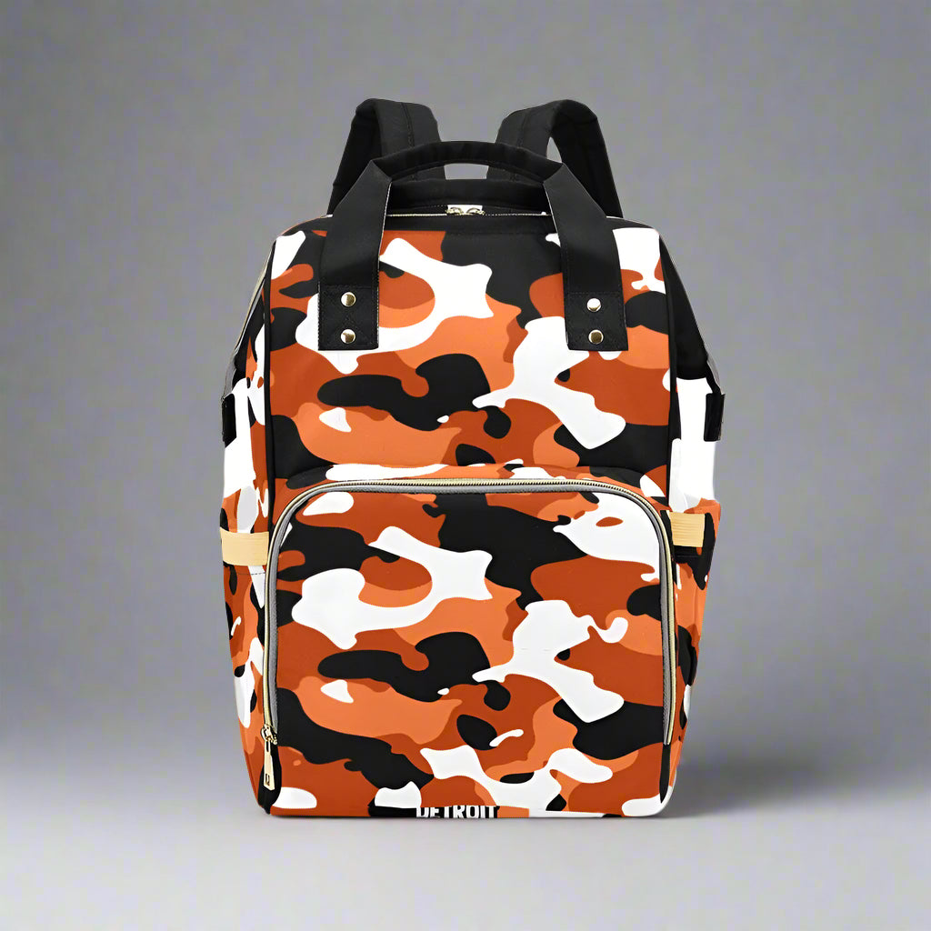 Camouflage-patterned backpack with orange, black, and white design on a white background