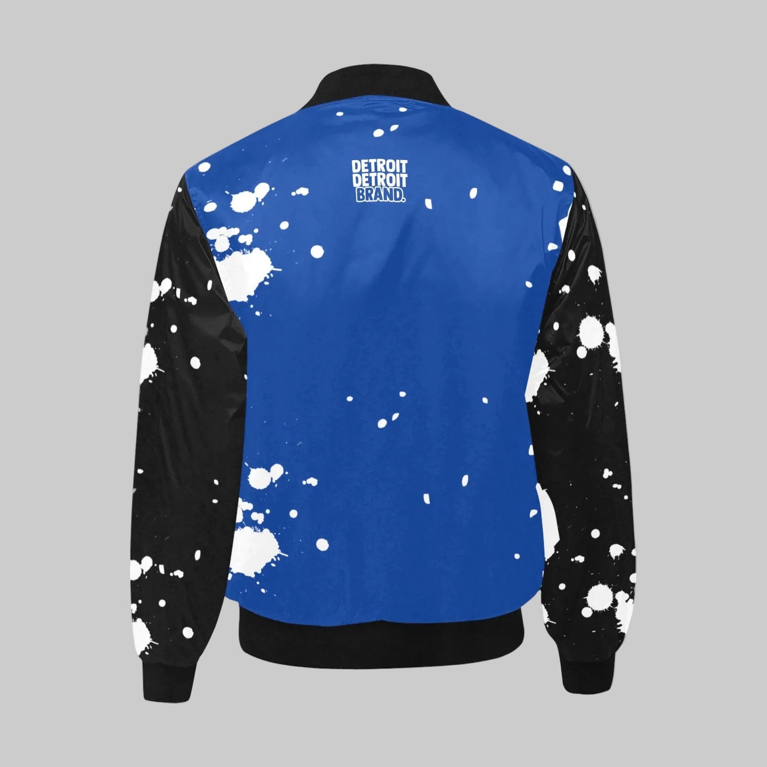 Blue jacket with black sleeves and white splatter patterns on a white background