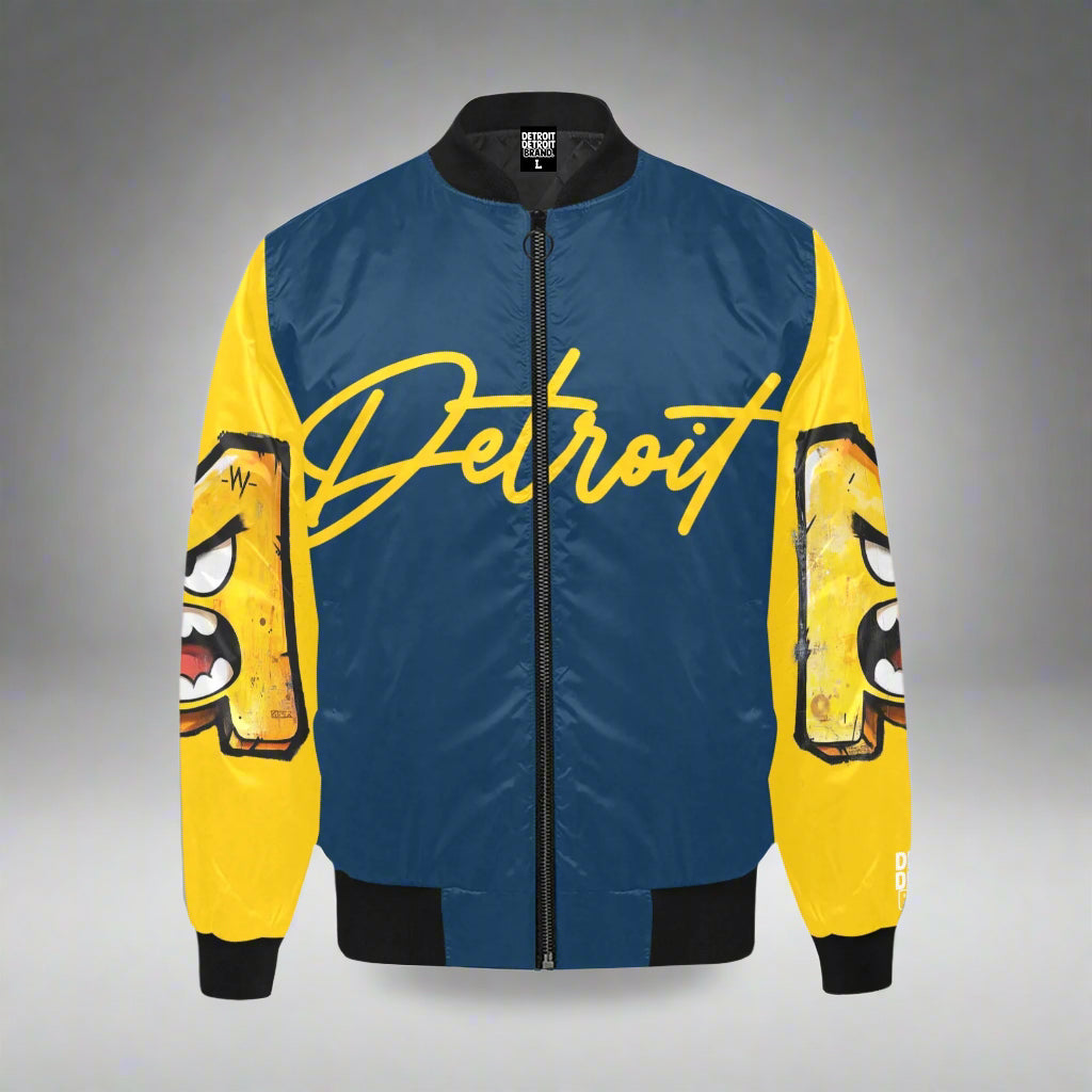 Blue and yellow Detroit bomber jacket featuring large yellow “Detroit” script across the chest and cartoon-style angry face graphics on both sleeves, with black collar, cuffs, and waistband.