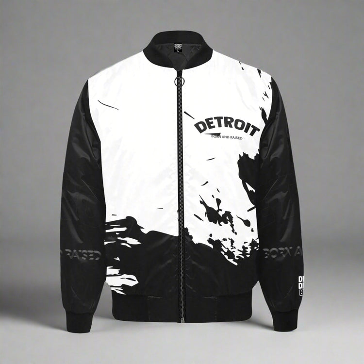 Black and white Detroit ‘Born and Raised’ splash-design bomber jacket with full front zipper and monochrome streetwear style