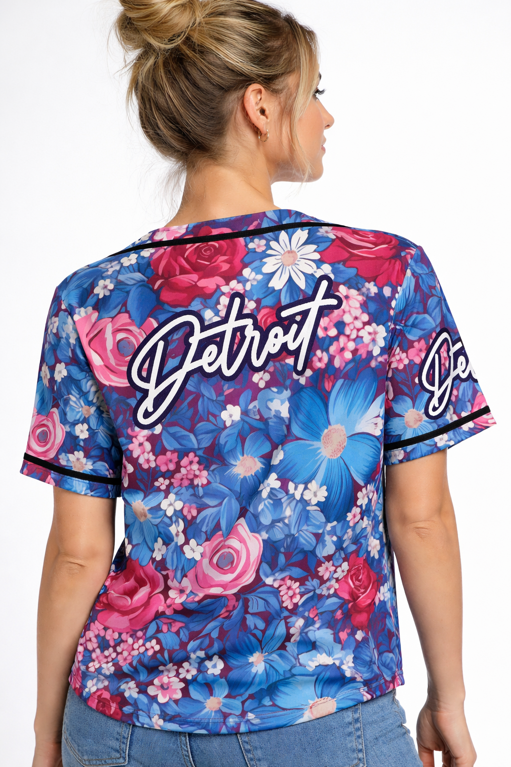 Back view of women’s Detroit floral baseball jersey featuring large Detroit script logo and bold blue and pink floral design
