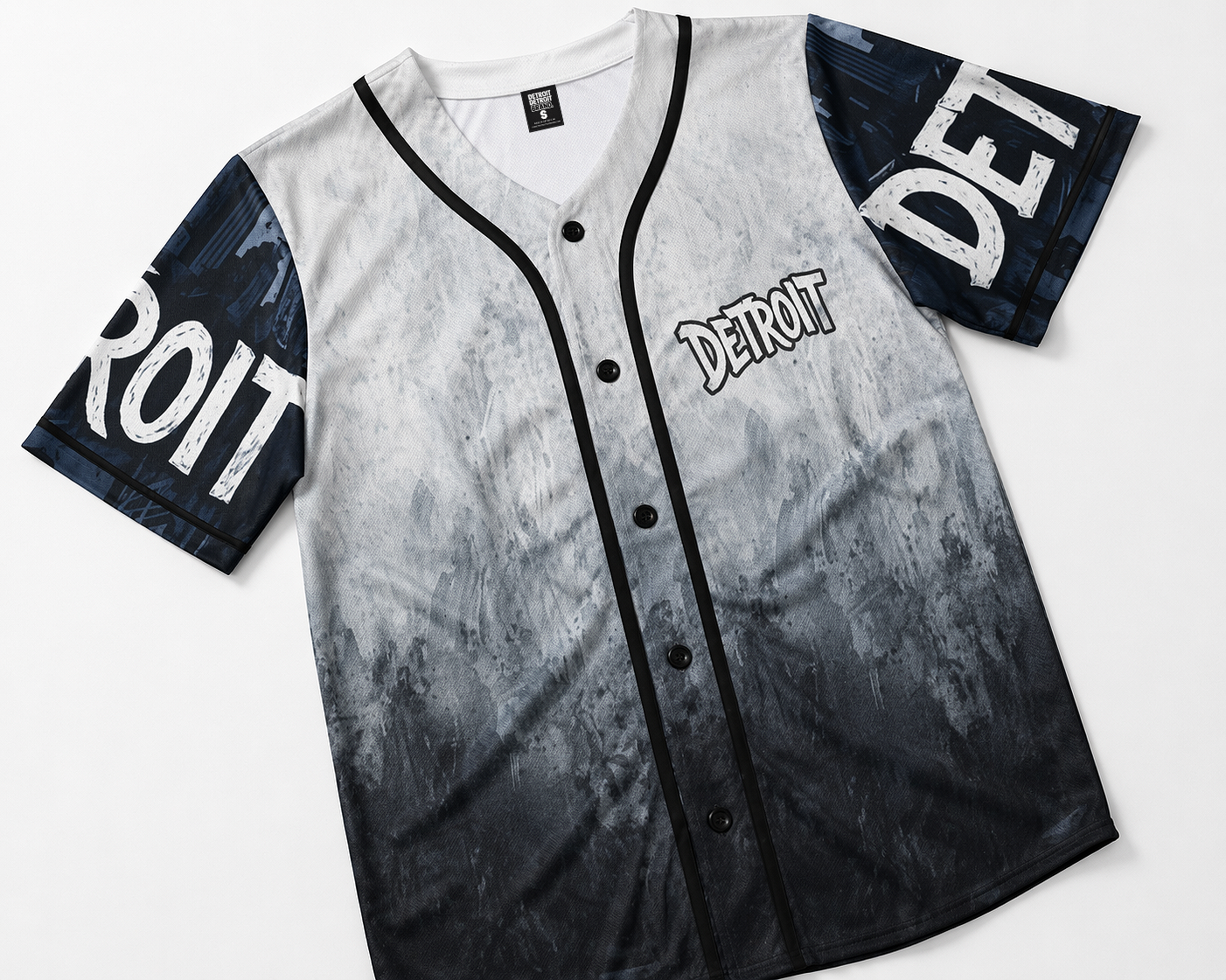 Flat lay detail of Detroit grey and black baseball jersey featuring gradient design, button front, black piping, and distressed sleeve graphics on white background