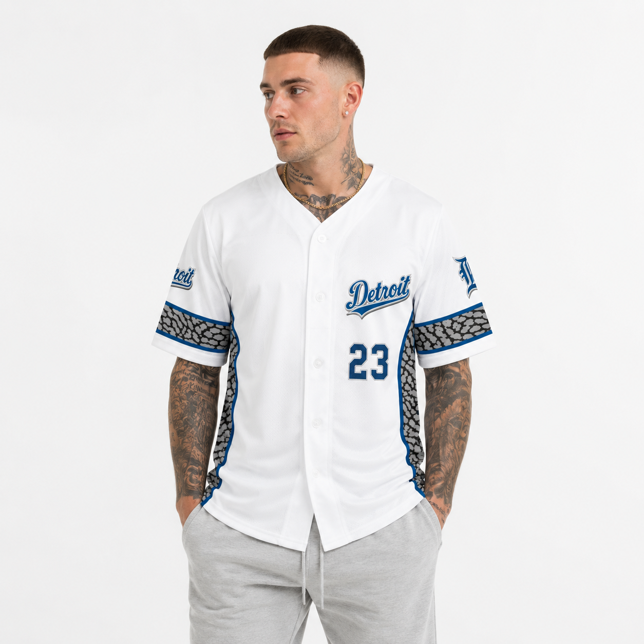 White male model wearing the Detroit Heritage White & Blue Baseball Jersey with grey athletic sweatpants in a clean studio setting, showcasing the front design.