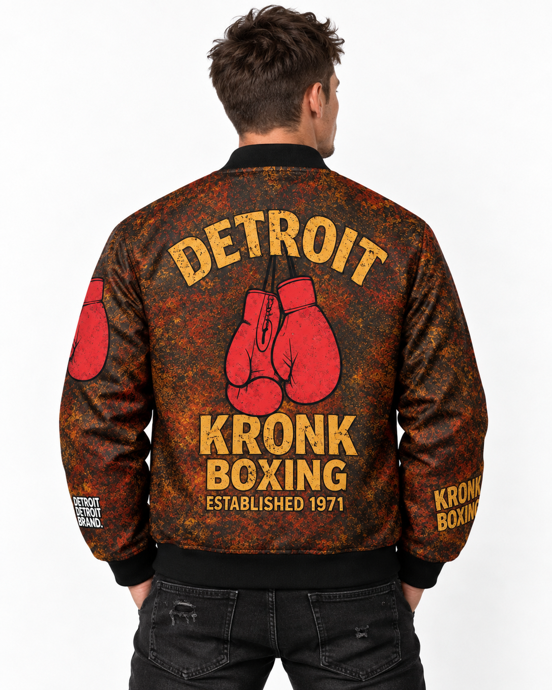 Male model wearing Detroit Kronk Boxing graphic bomber jacket showing boxing gloves and Detroit back design