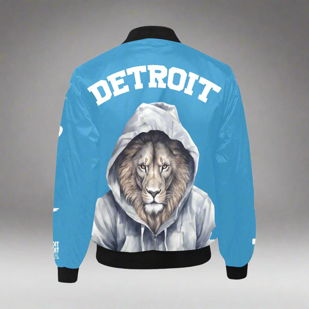 Back view of a blue Detroit bomber jacket featuring a detailed illustration of a lion wearing a gray hoodie and bold white “Detroit” lettering across the upper back, with black cuffs and waistband.