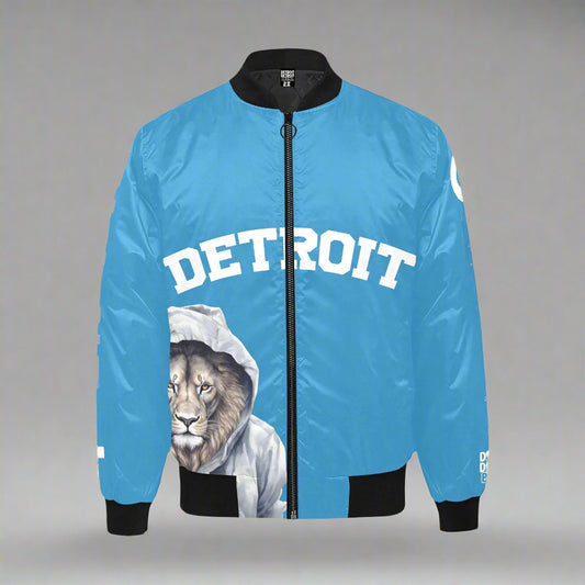 Blue Detroit bomber jacket with black sleeves and cuffs, featuring bold white “Detroit” text across the chest and a detailed illustration of a lion wearing a gray hoodie on the lower front.