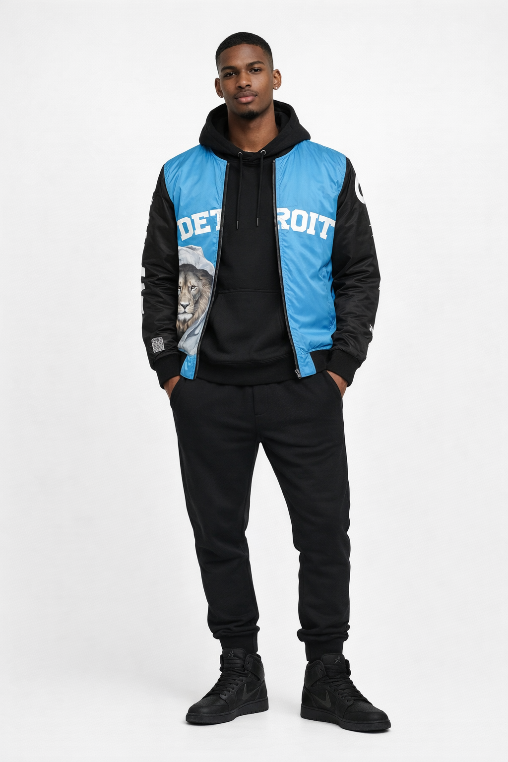 Man wearing a black and blue jacket with 'Detroit' text on a white background