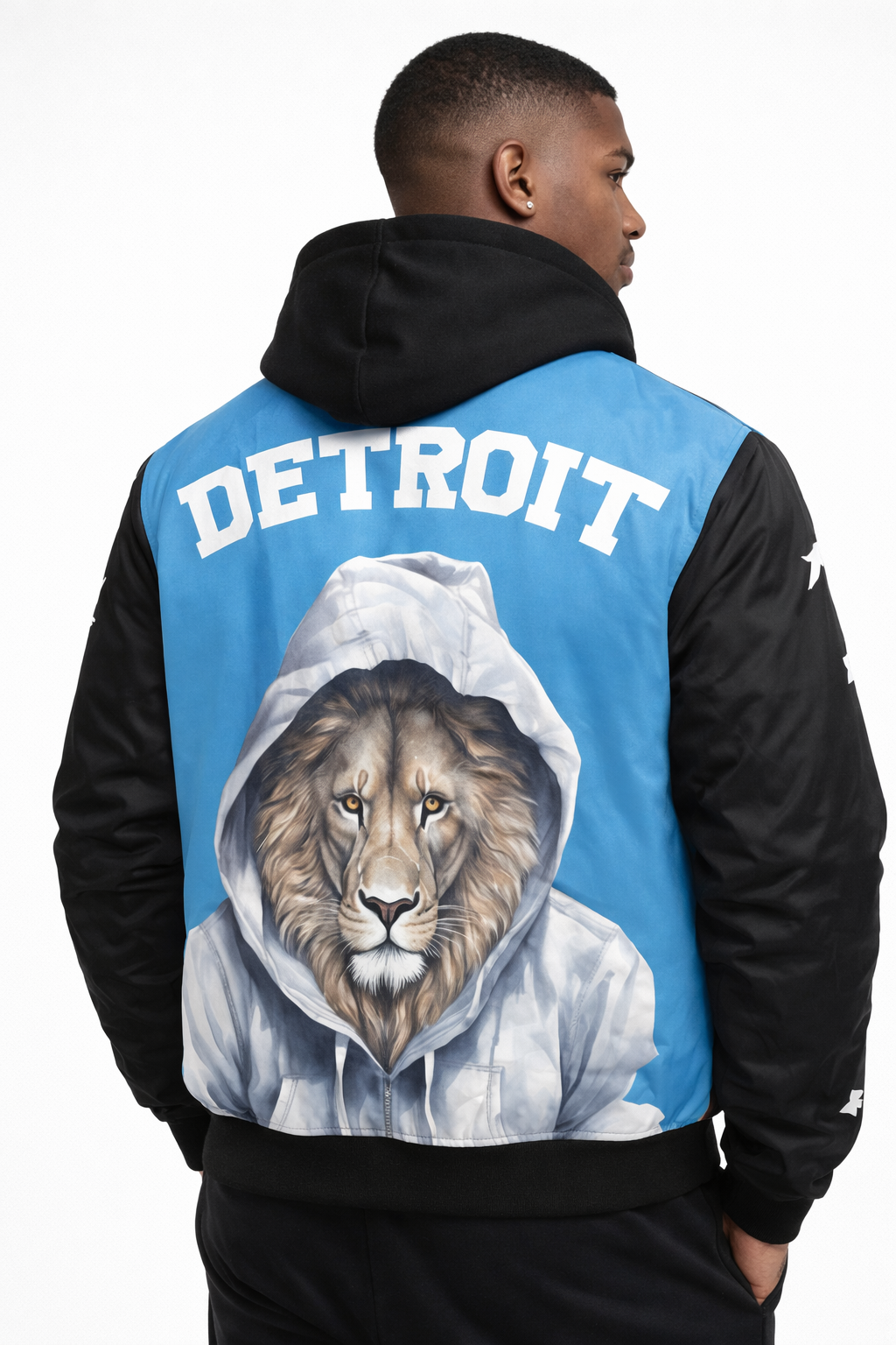 Person wearing a black and blue jacket with a Detroit lions graphic and 'Detroit' text on the back.