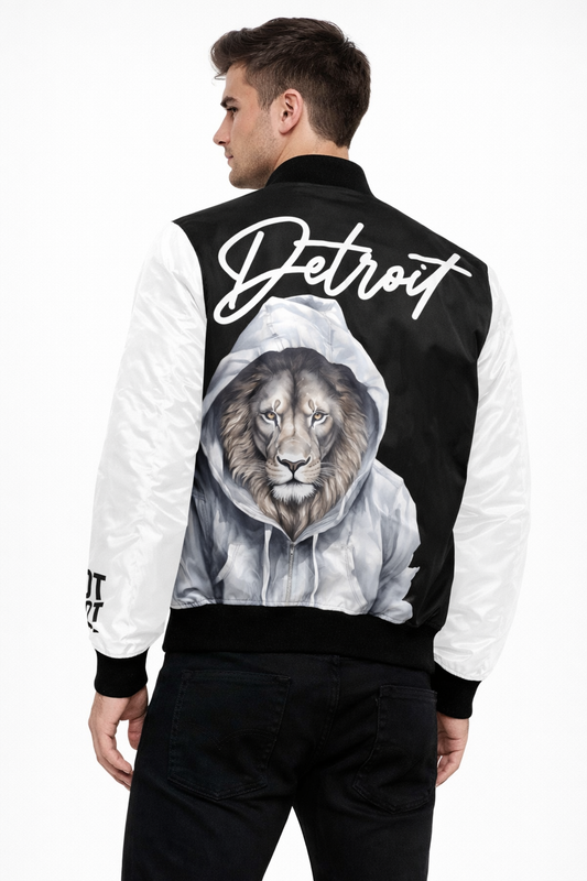 Back view of male model wearing black and white Detroit varsity bomber jacket featuring lion graphic artwork and Detroit script on back