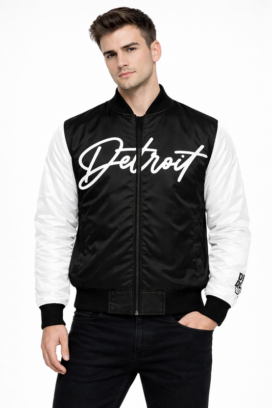 Front view of male model wearing black and white Detroit varsity bomber jacket with Detroit script logo on chest