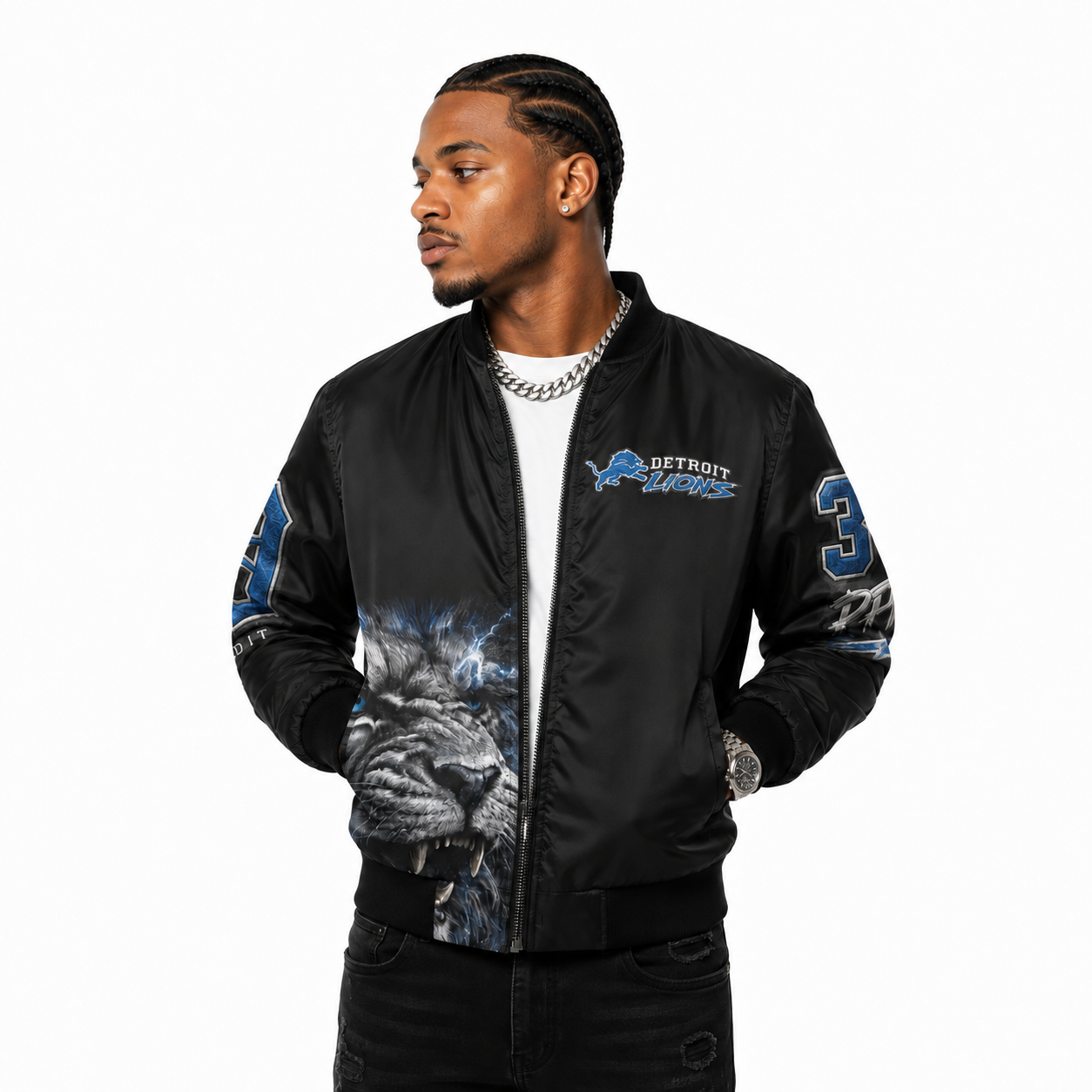 Male model wearing a black Detroit Lions bomber jacket with a silver Cuban link on a white studio background