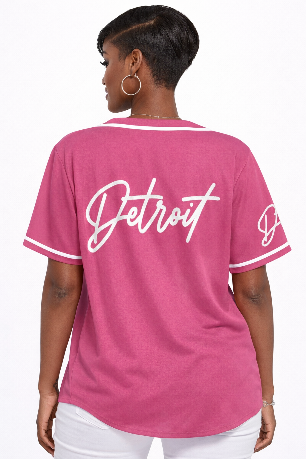 Back view of women’s pink Detroit baseball jersey featuring large Detroit script logo and white trim details