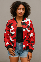 Person wearing a red and black camouflage bomber jacket with a plain background
