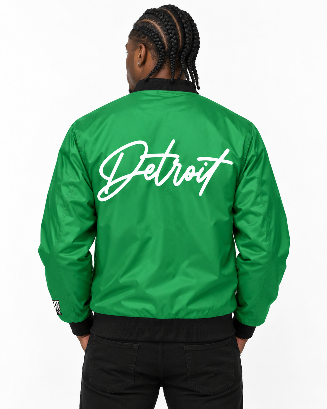 Male model wearing green Detroit Script Bomber Jacket with large white Detroit lettering on back