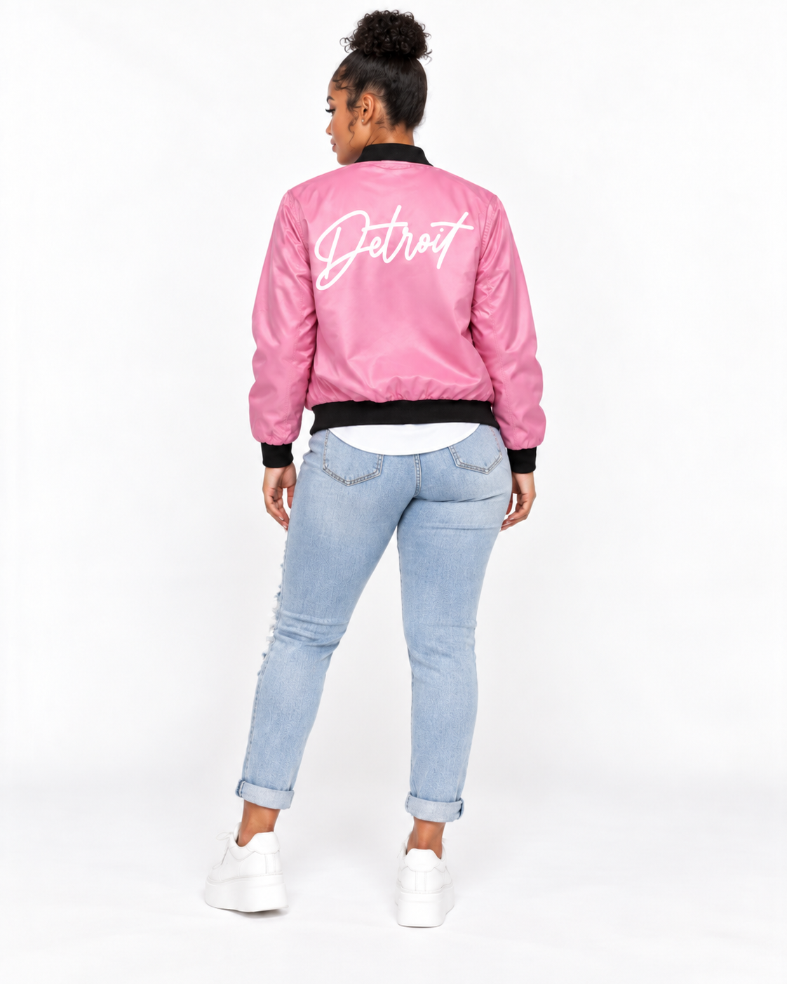 Female model showing back of Detroit Script pink bomber jacket with white Detroit lettering