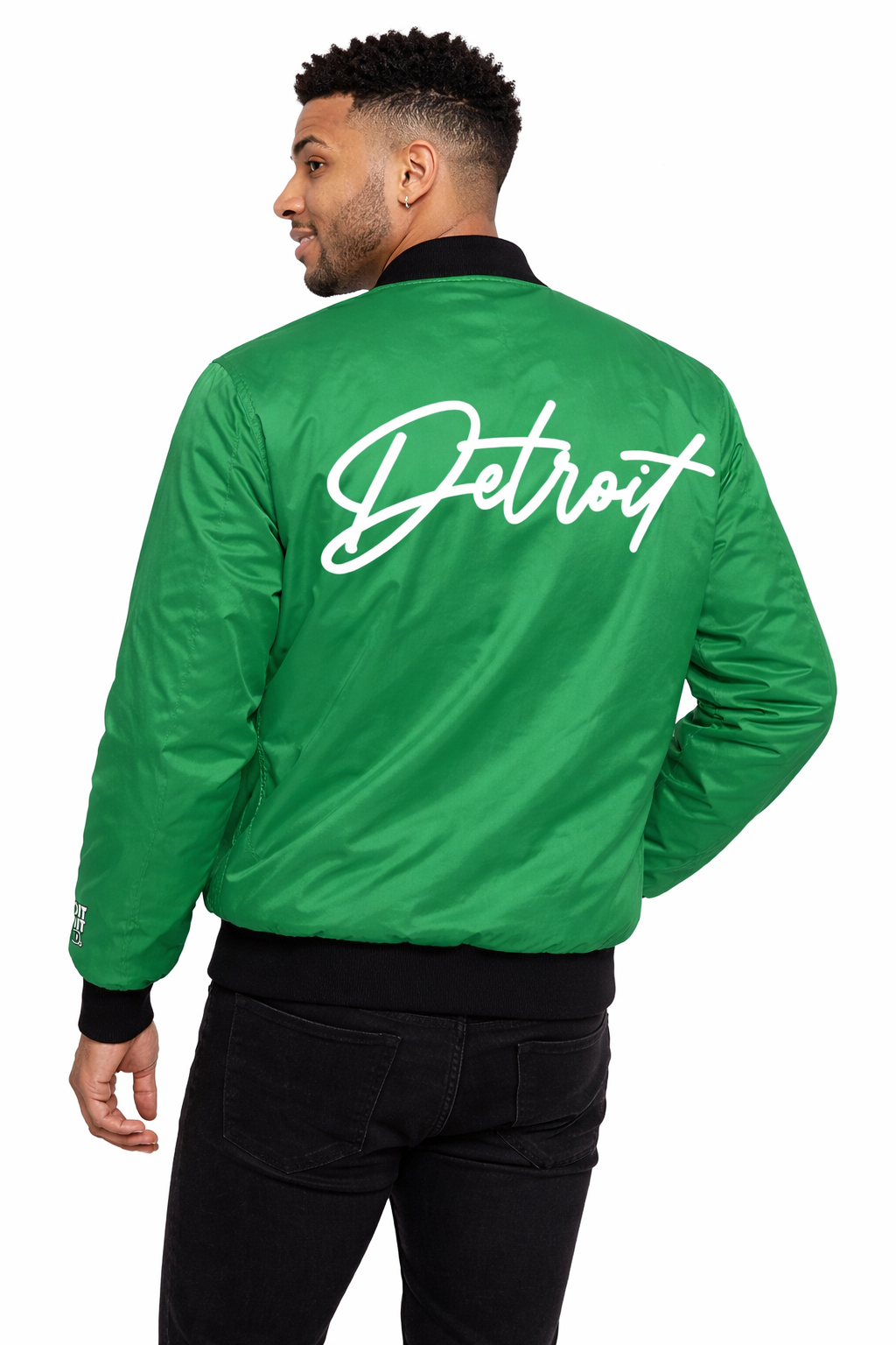 Person wearing a green jacket with 'Detroit' written on the back against a white background