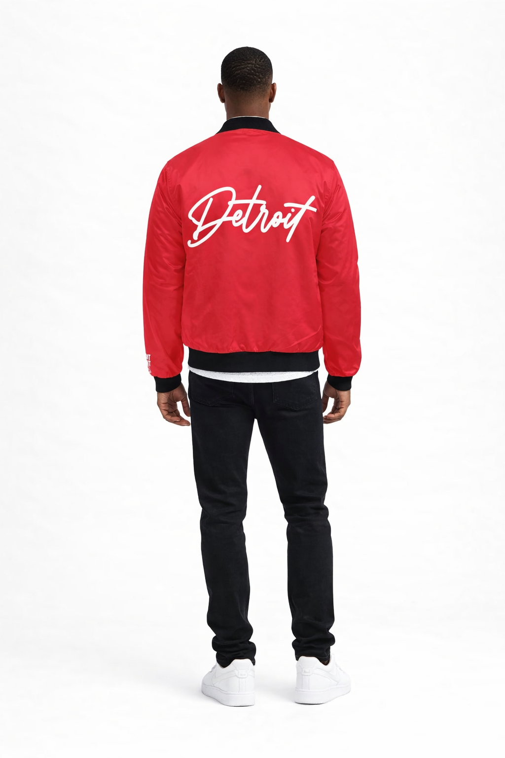 Person wearing a red jacket with 'Detroit' text on the back, standing against a white background