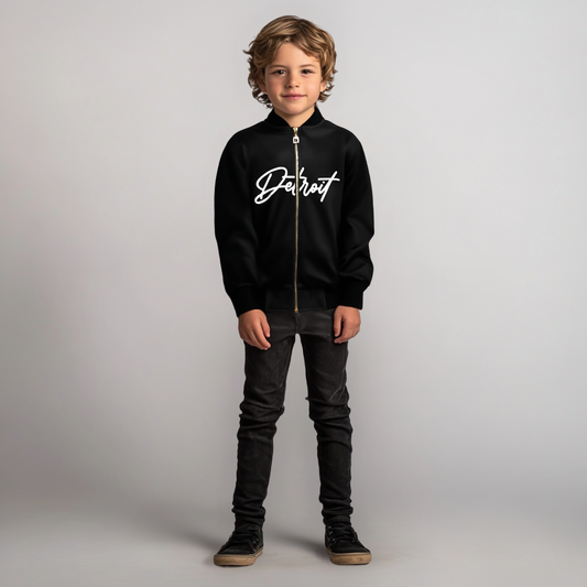 Child wearing a black hoodie with 'Detroit' text on a plain background