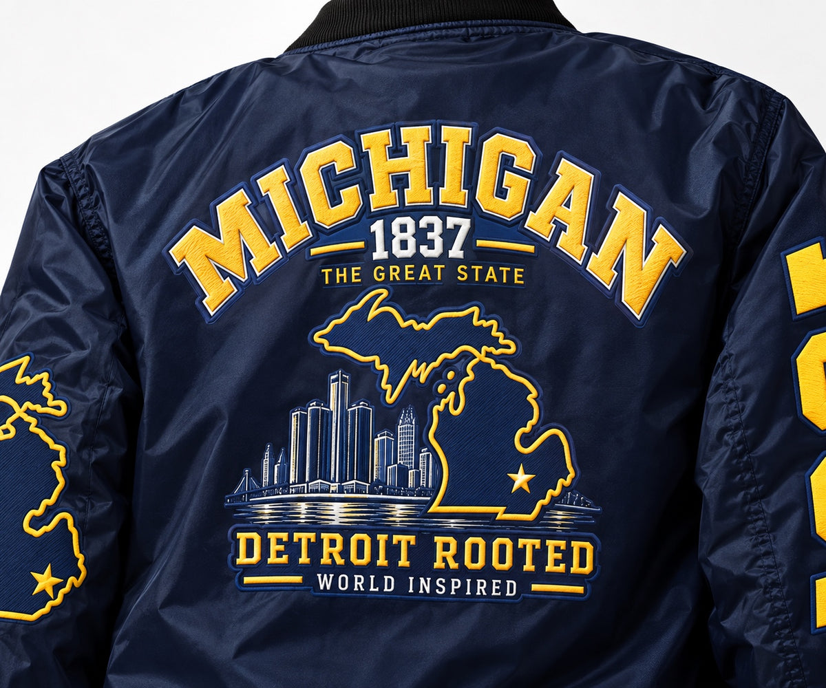 Close-up back detail of Michigan Detroit Rooted Bomber Jacket with printed Michigan map, Detroit skyline and navy maize graphics