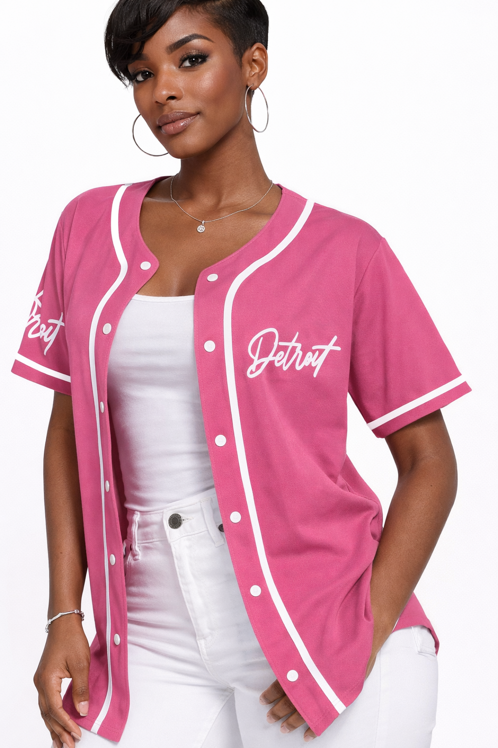 Woman wearing a pink 'Detroit' baseball jacket on a white background