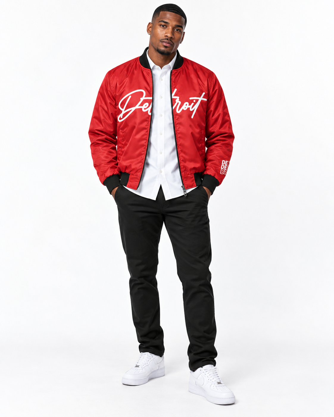    Male model wearing red Detroit Script Bomber Jacket with white shirt, black jeans and white sneakers